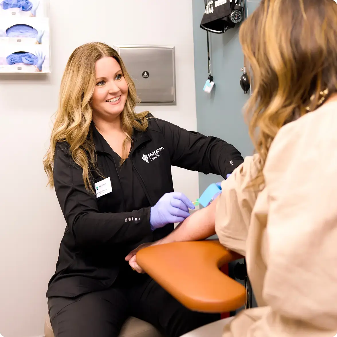 Marathon Health nurse taking a patient's blood sample in a clinical setting.