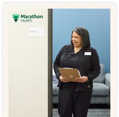 Marathon Health HR team member holding a clipboard.