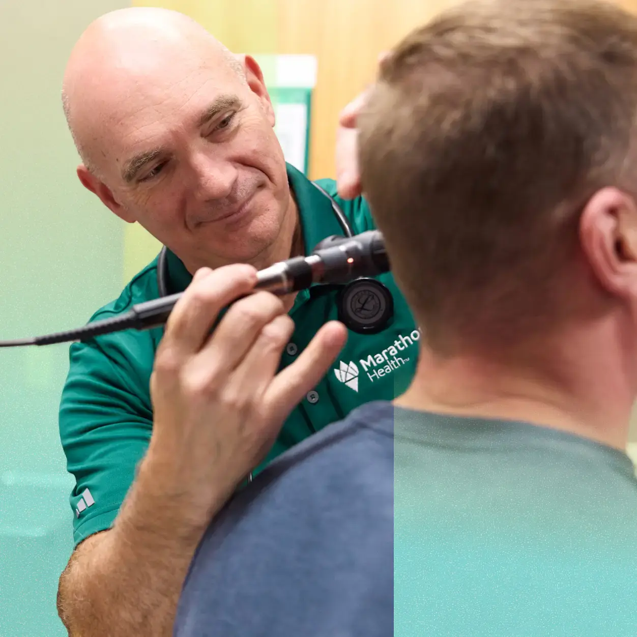 Doctor checking a patient's ear.