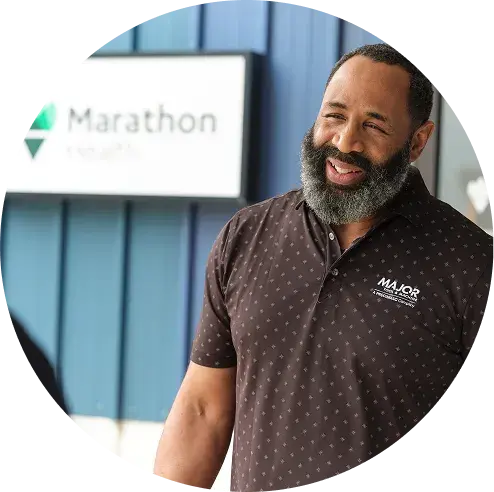 Man standing in front of a Marathon Health onsite health center.