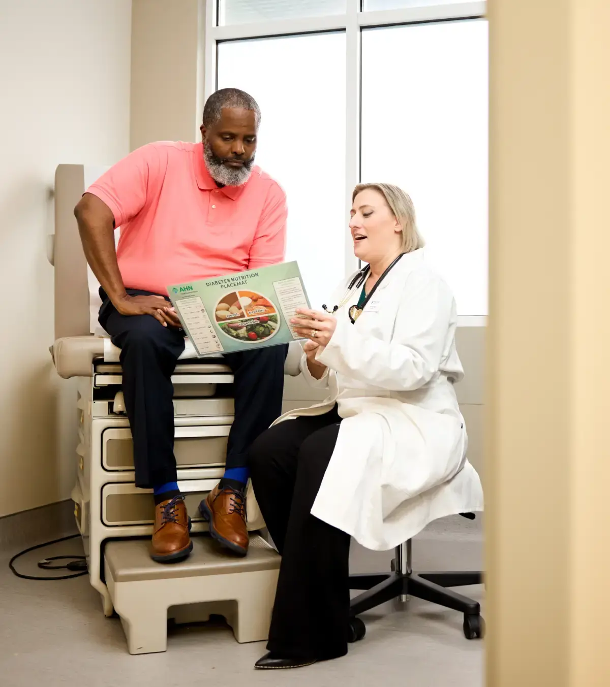 Patient and doctor going over the food pyramid.