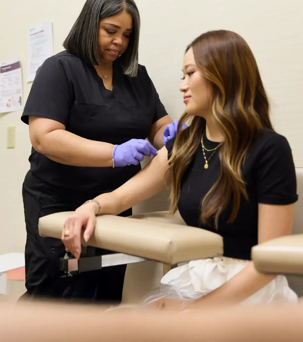 Healthcare practitioner drawing blood from a patient.