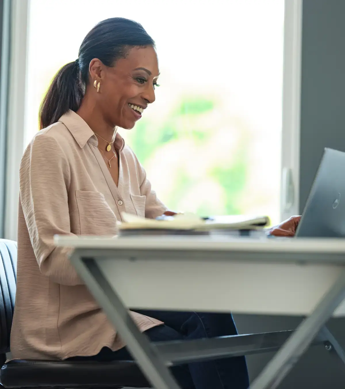 Woman looking at a laptop during a virtual care call.
