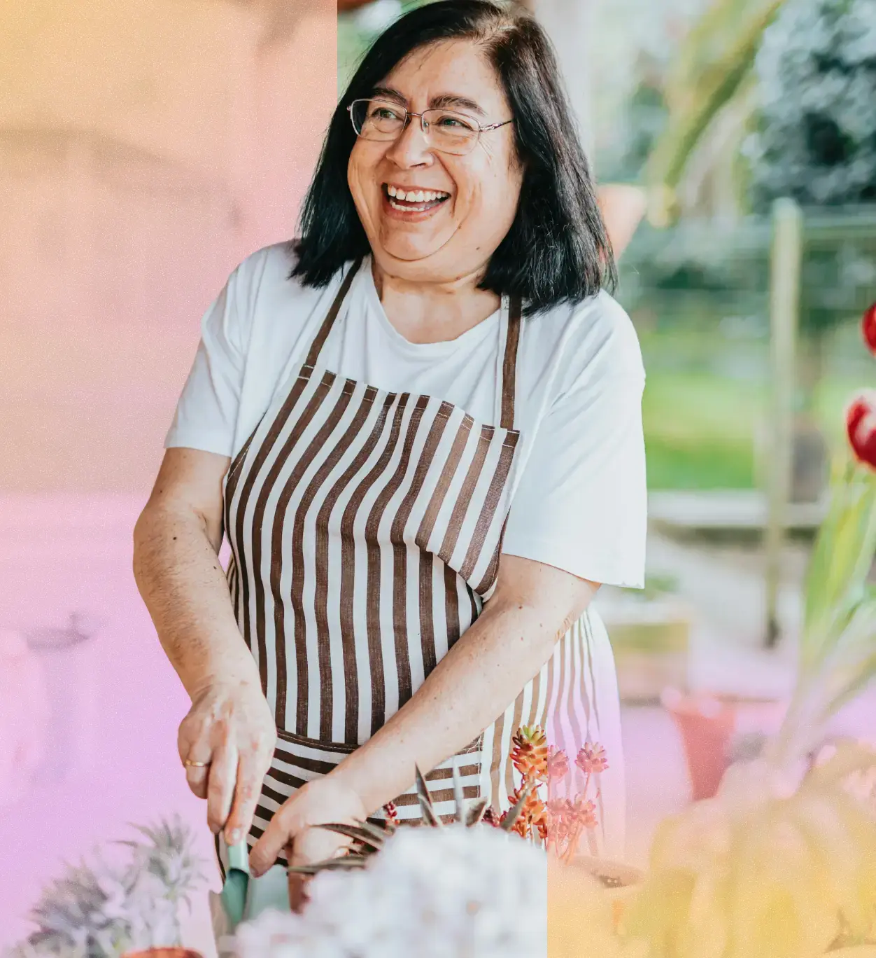 Woman in a colorful apron gardening. 