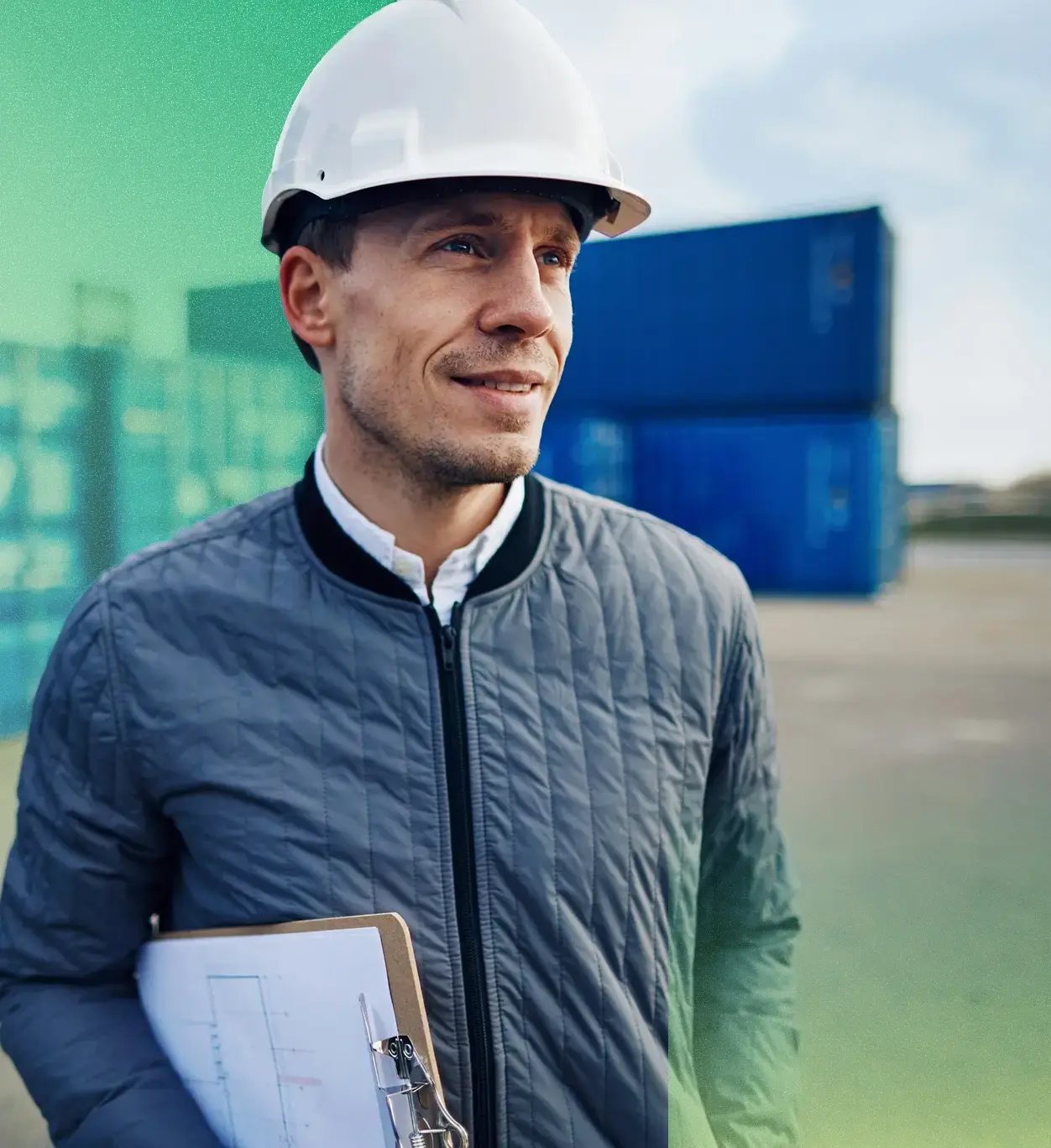 Shipping dock worker in a hardhat carrying a clipboard.