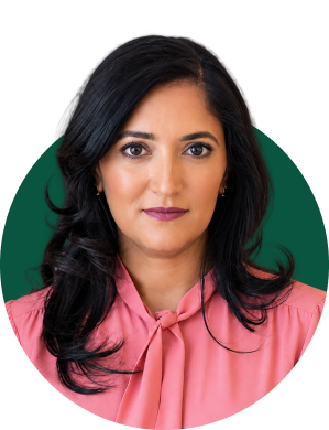 Dr. Kavita Patel, primary care physician, venture advisor, and former Obama White House policy director, stands in a professional setting wearing a pink blouse.