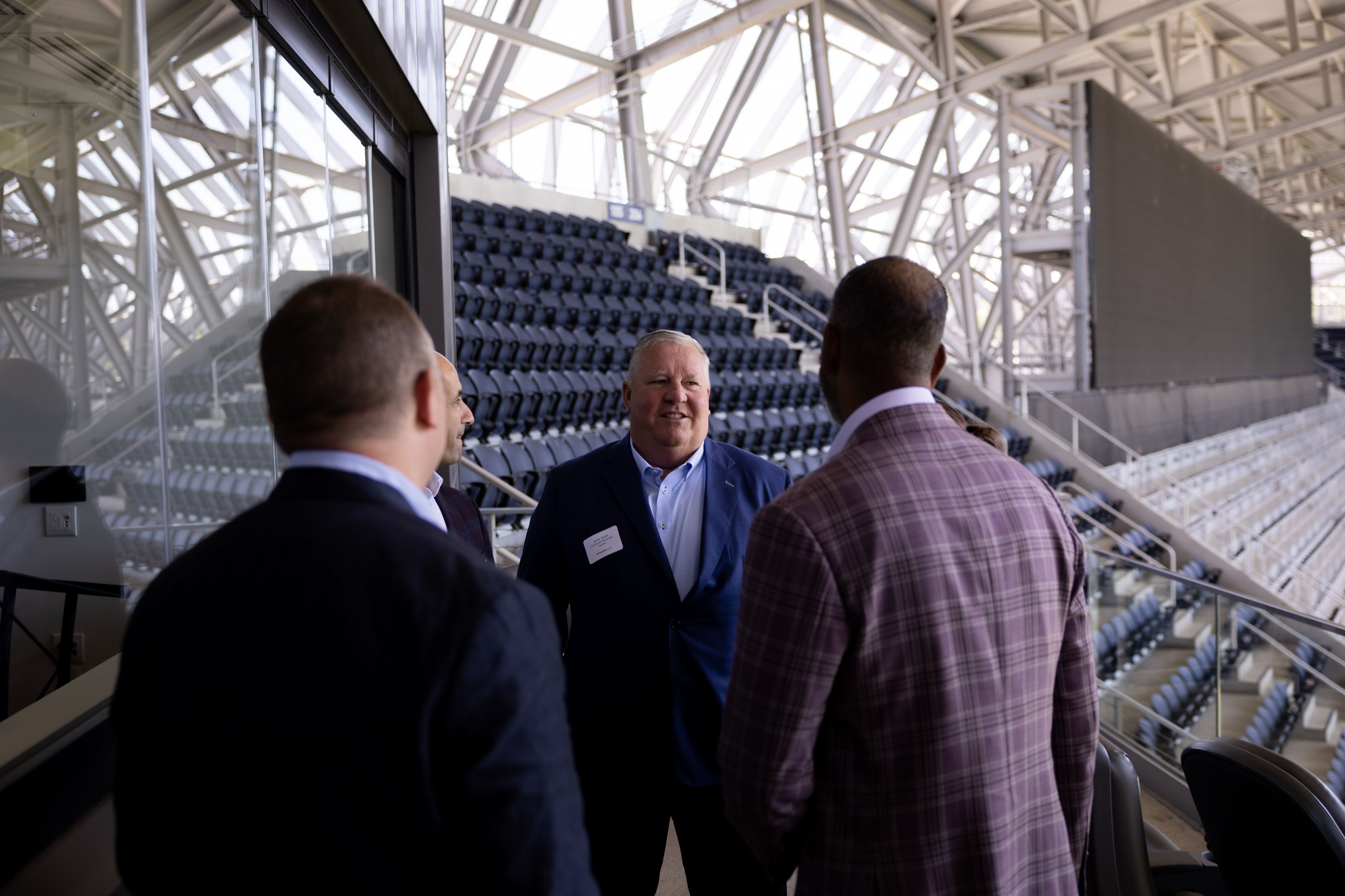 Attendees tour the seating bowl at TQL Stadium during the Marathon Health event.
