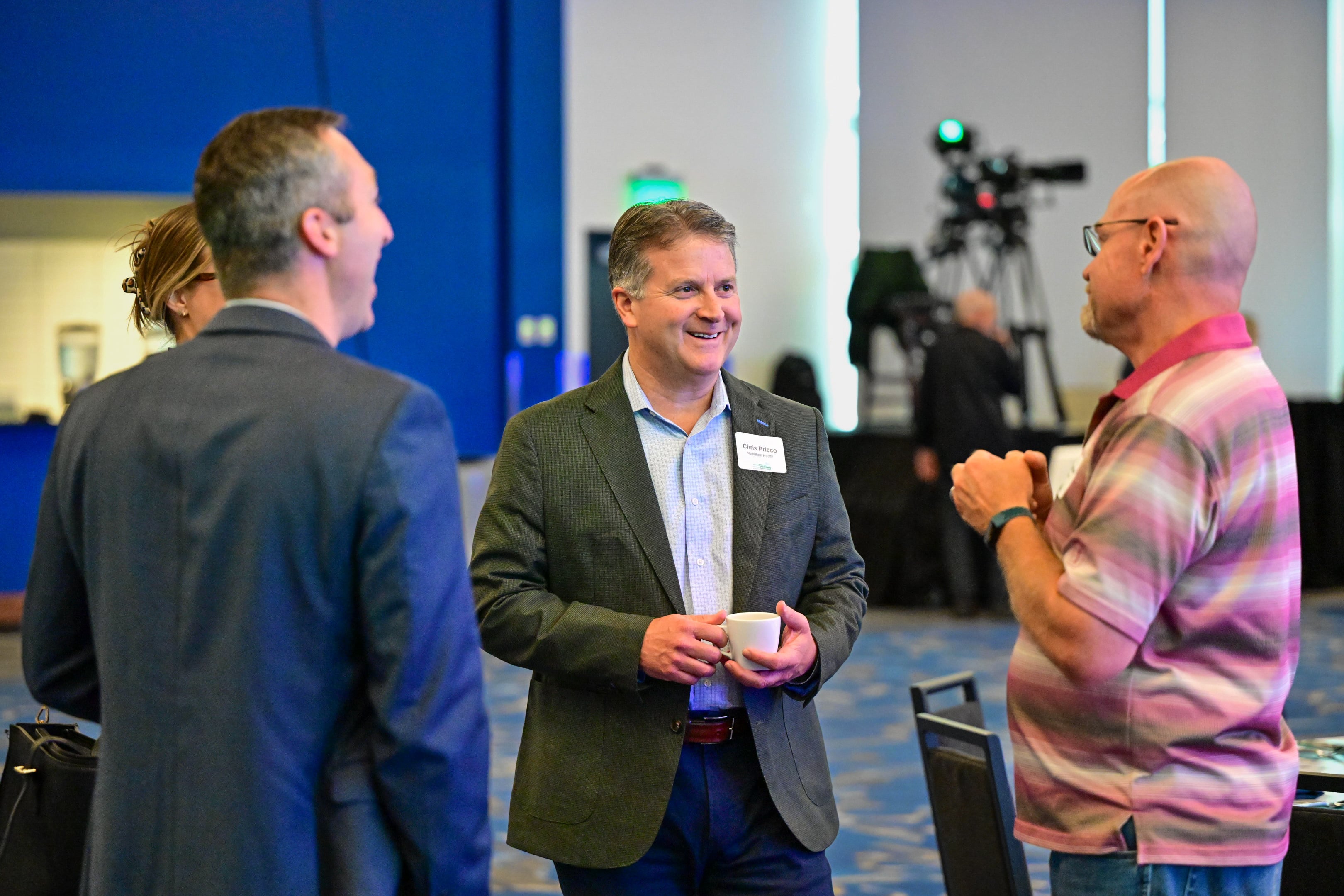 Chris Pricco and attendees network during the Whole Health, Stronger Workforce Indiana Roundtable.