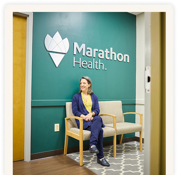 Woman seated in a Marathon Health waiting room.