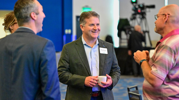 Chris Pricco and attendees network during the Whole Health, Stronger Workforce Indiana Roundtable.