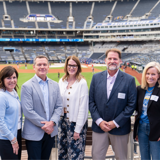 Kansas City healthcare barriers roundtable speakers Shelly Summar, Doug Sumner, Stacie Prosser, Dennis Kadel, and Stephanie Price pose together at Kauffman Stadium.