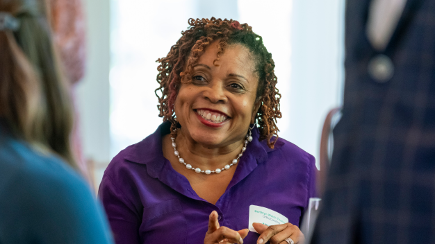 Attendee smiling at the Marathon Health Charlotte roundtable.