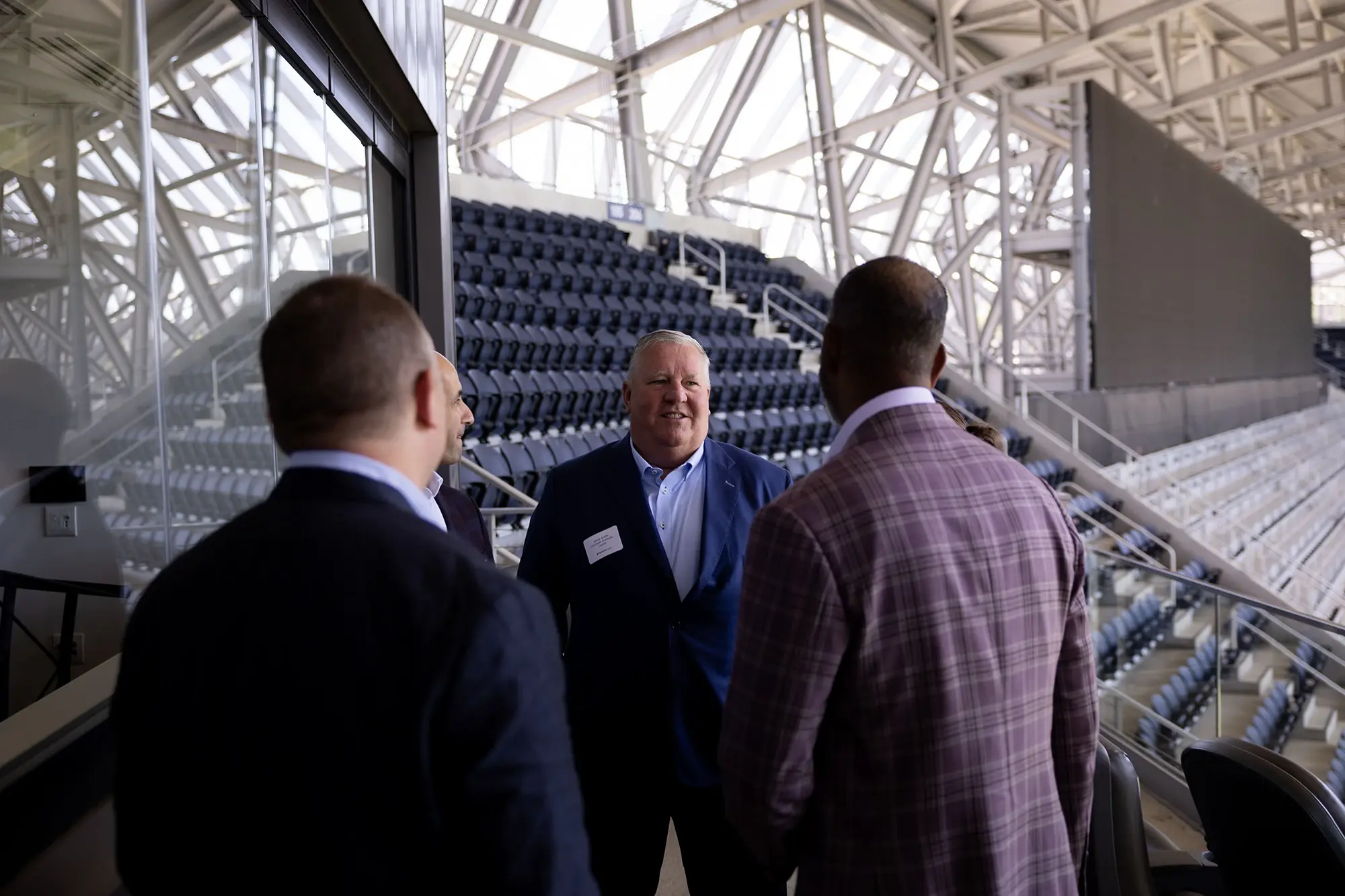 Attendees tour the seating bowl at TQL Stadium during the Marathon Health event.
