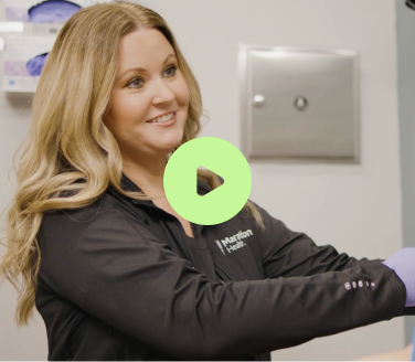 Marathon Health provider demonstrating care in clinic.