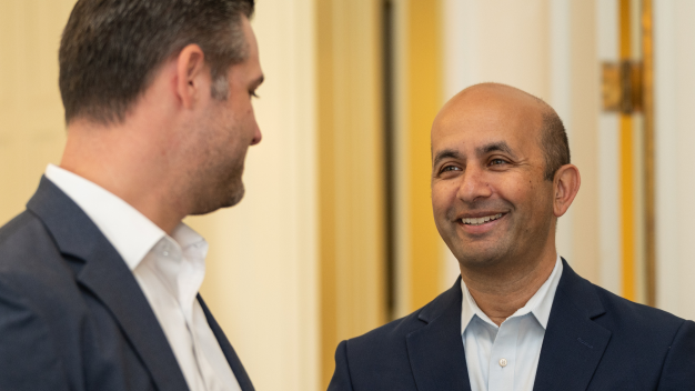 Dr. Nirav Vakharia smiling and networking at the Marathon Health Richmond forum.