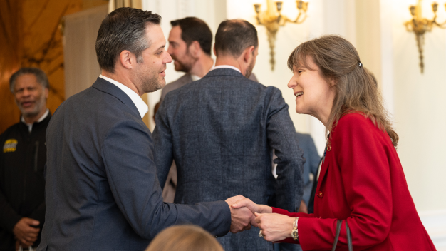 Attendees greet each other with a handshake at the Marathon Health Richmond forum.
