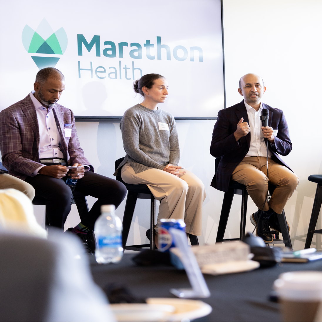 Marc Watkins, Evelyn Hemmingsen, and Nirav Vakharia seated in front of a Marathon Health screen at the Ohio roundtable.