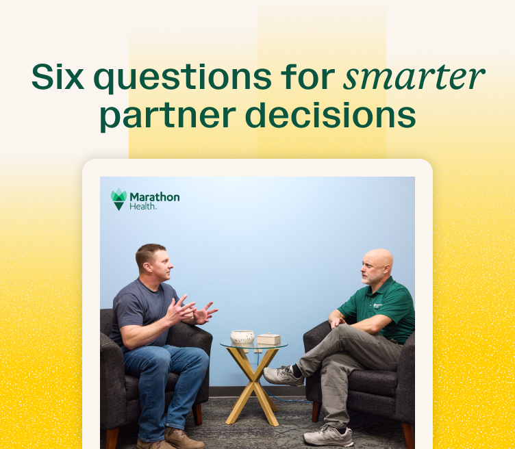 Two professionals in conversation for a resource about choosing an advanced primary care partner.