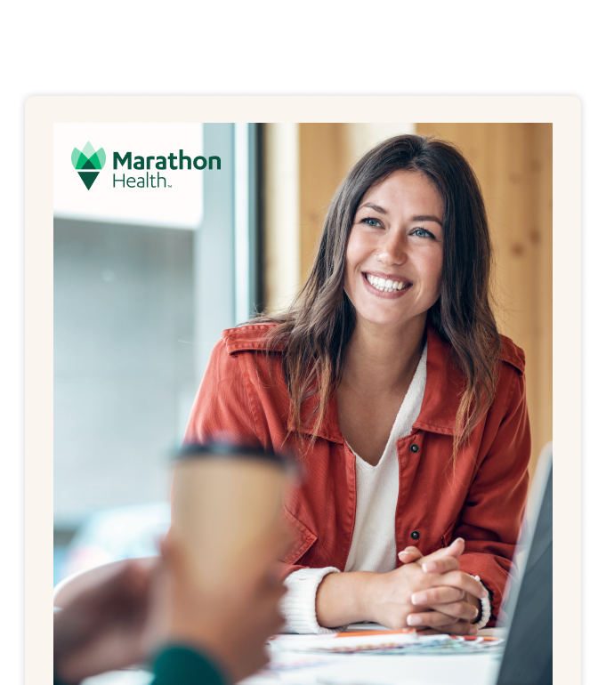 Report cover with the Marathon Health logo: a smiling person in an orange jacket at a cafe table with a laptop