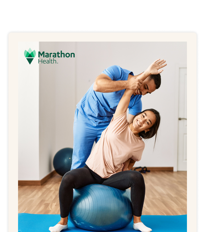 A provider in scrubs guides a person stretching on an exercise ball